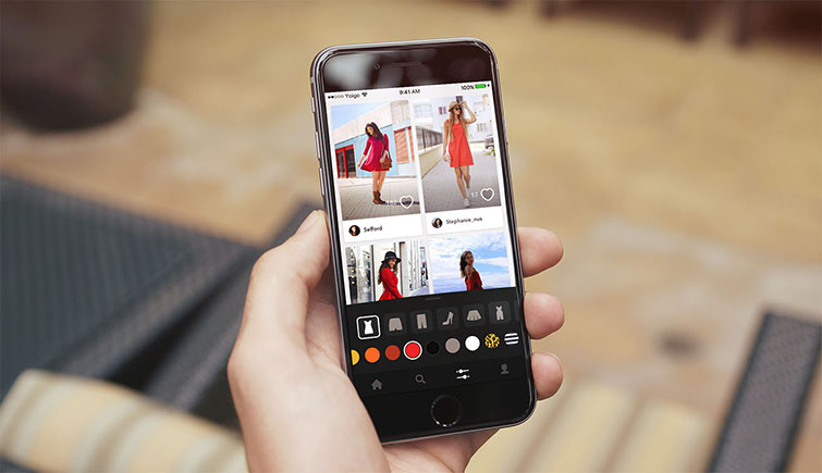 Iphone nelle mani di una persona con schermata di una app per abbinare colori vestiti