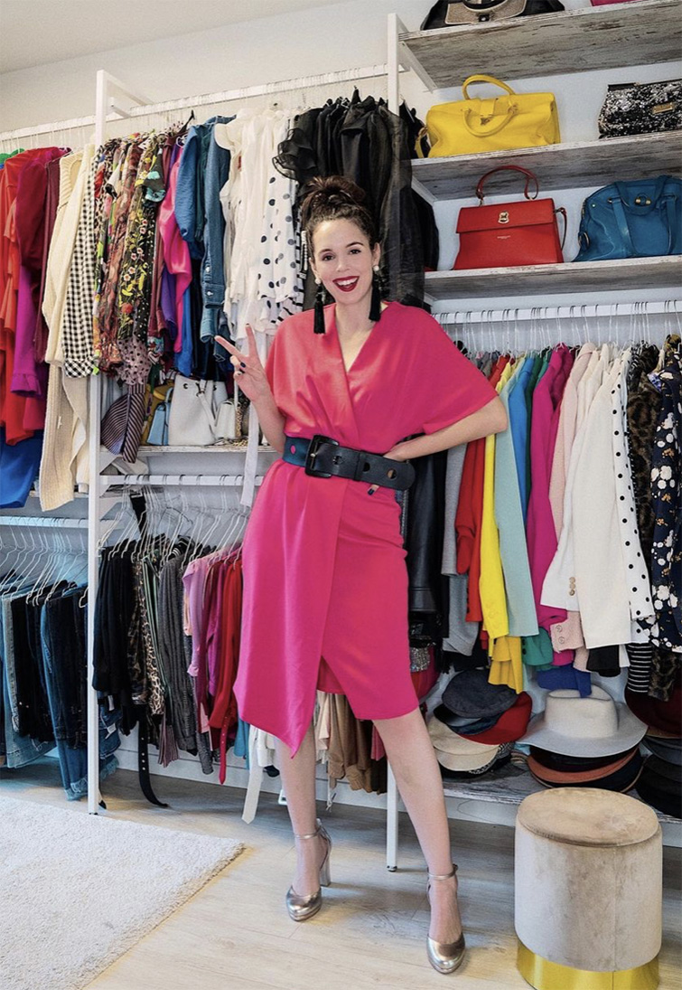  Influencer italiana Irene Colzi con un vestito rosa e un cinturnone nero che sorride alla fotocamera