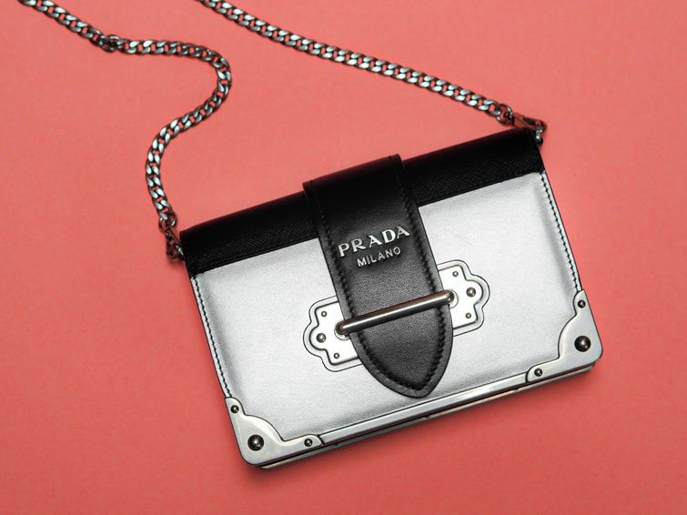 borsa di Prada Milano argento e nera con catena su sfondo rosso: una delle migliori borse di marca a poco prezzo